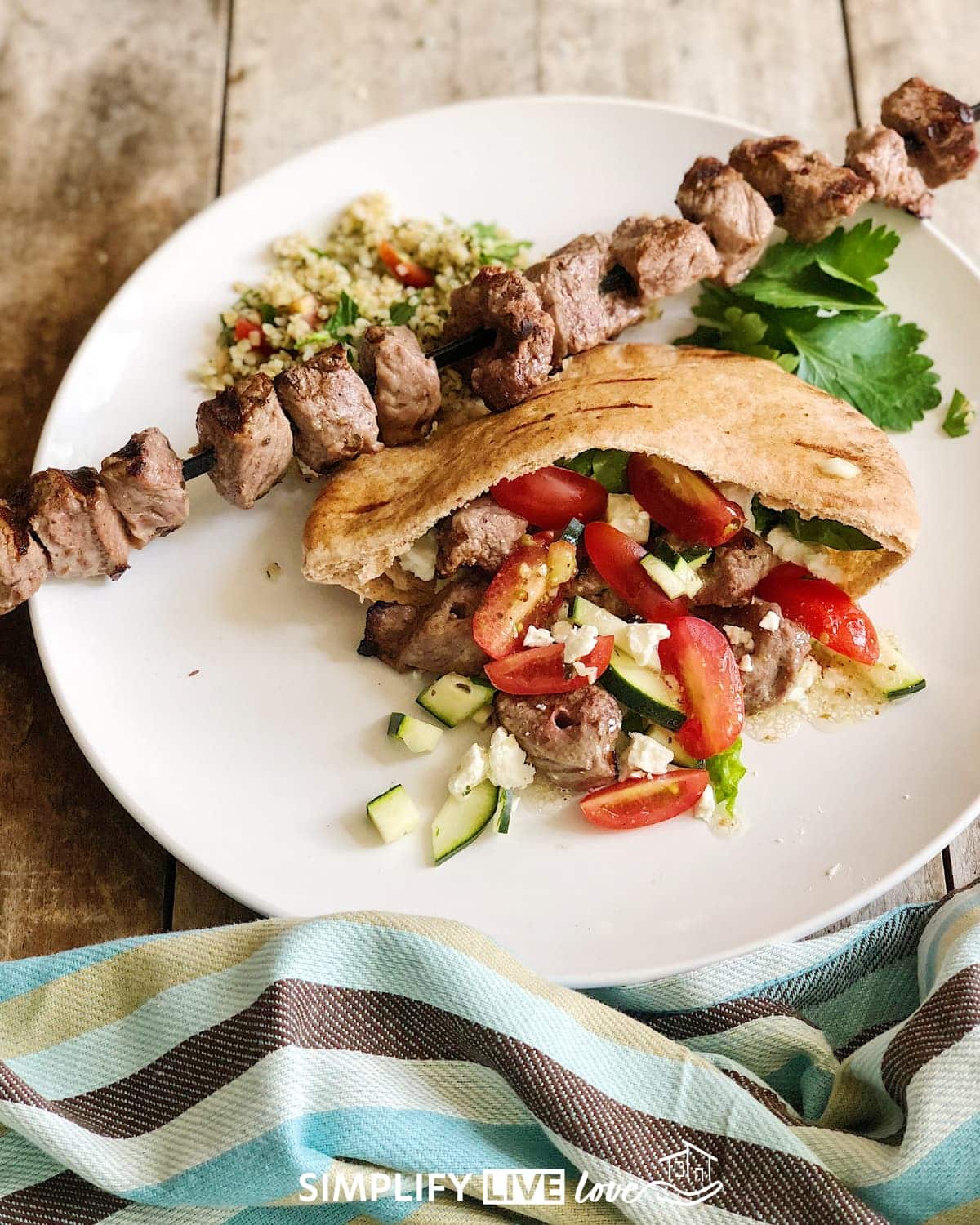 beef pita sandwich with cucumbers, tomatoes, and feta