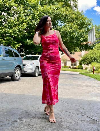 reviewer in red spaghetti strap dress with drapey neckline