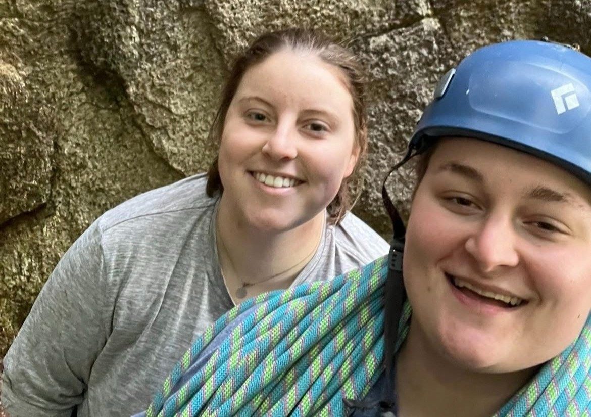 Shea and Maria taking a selfie in front of a rock face