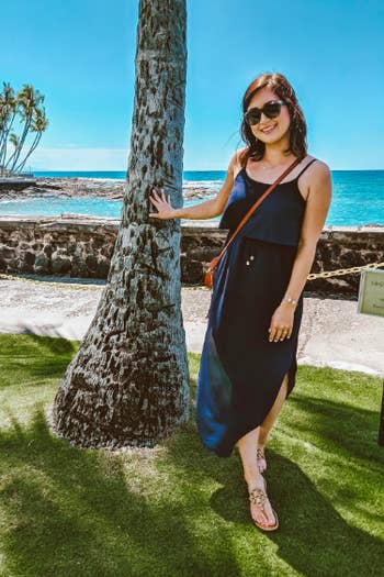 A reviewer in the dress in navy. The hemline is rounded with slits on the sides