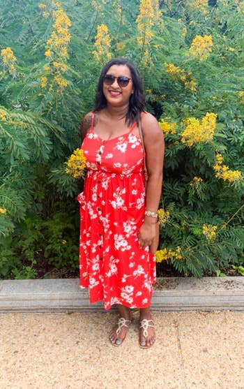 reviewer in red and white floral midi spaghetti strap dress with buttons