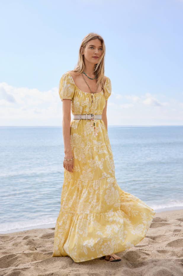 model on a beach wearing the dress belted