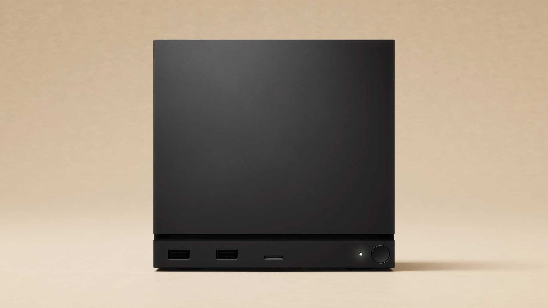 The front of the Steam Machine, a black square with a power button and USB ports at the bottom.