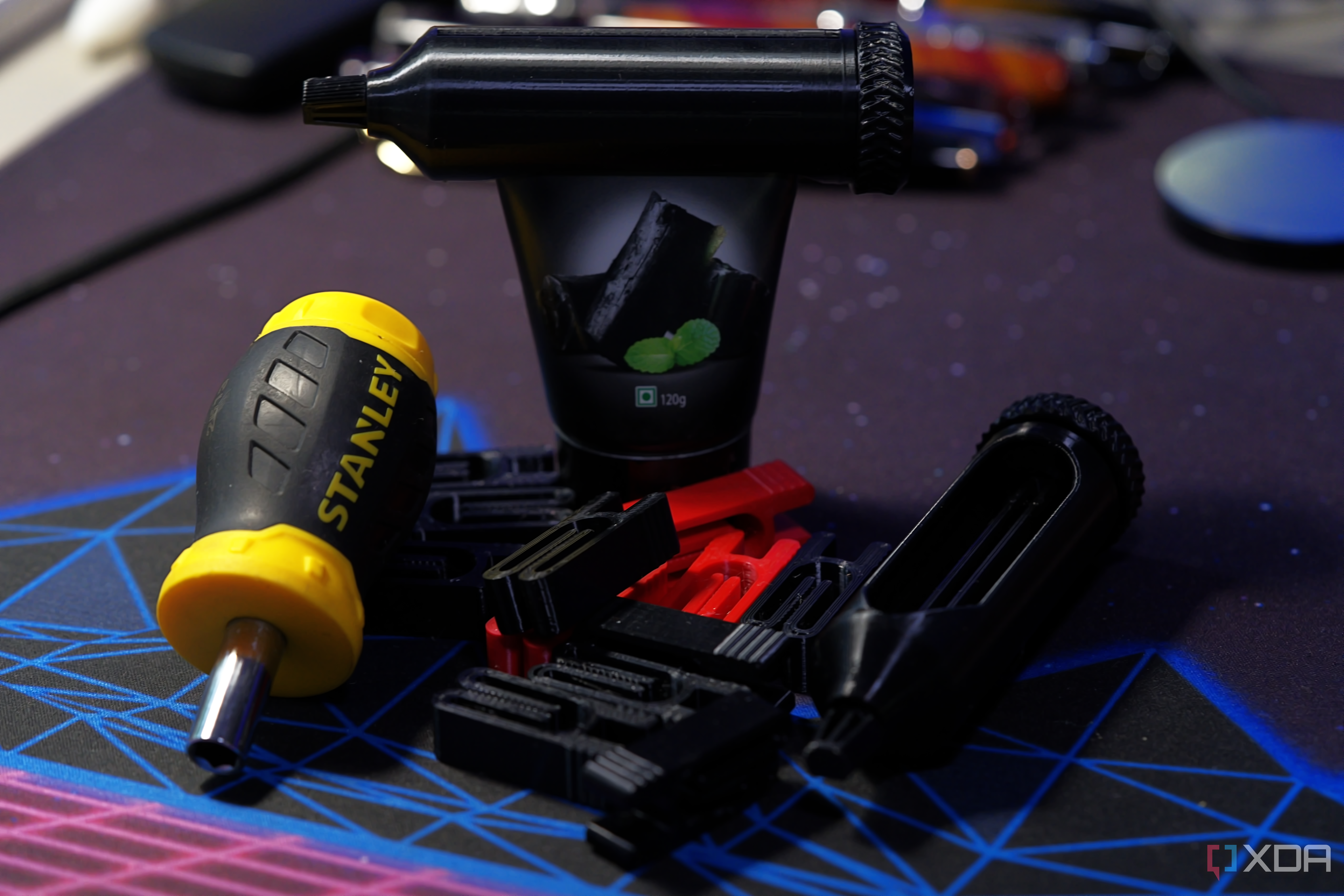 3D printed bag clips and tube squeezers on a purple deskmat