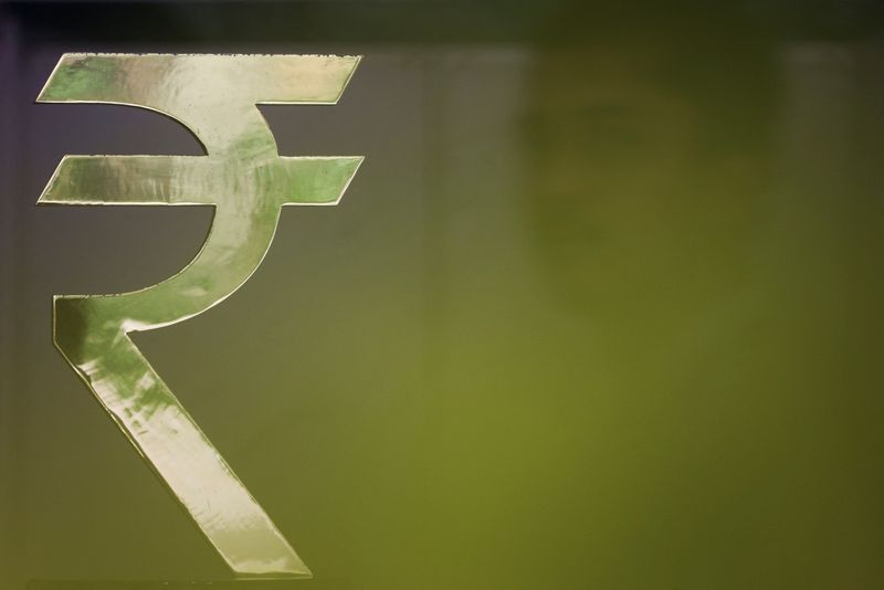 Central bank intervention, oil price dip help rupee edge modestly higher