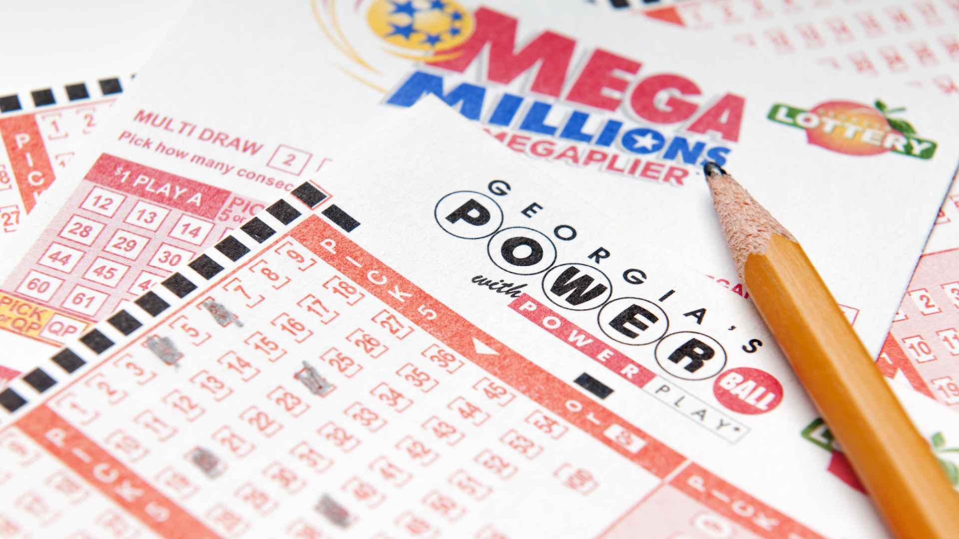 Discover an assortment of lottery tickets spread out, including Mega Millions and Powerball