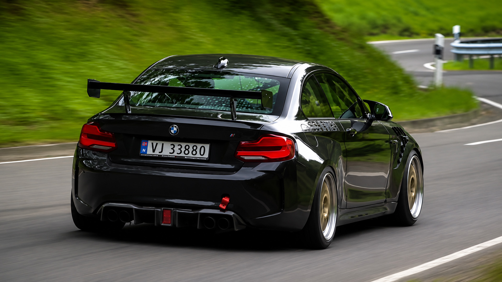 Modified BMW M2 goes full speed on curvy road