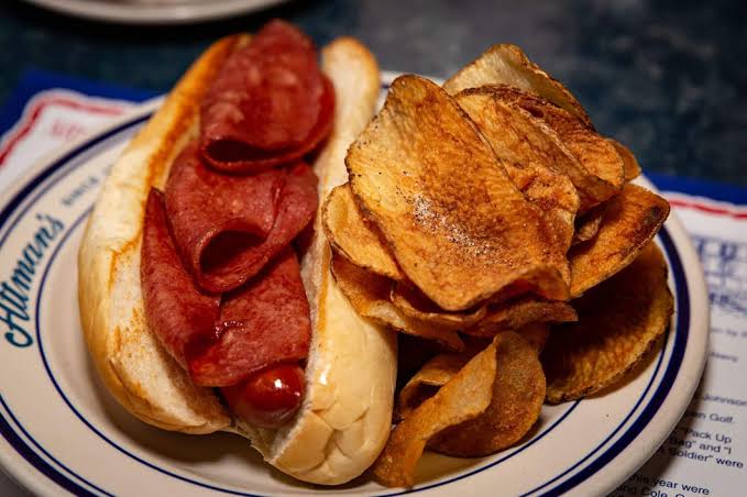 The Baltimore-style hot dog - like the one featured at Attman's Delicatessen - is a meat-on-meat masterpiece featuring a jumbo kosher beef frank topped with bologna.