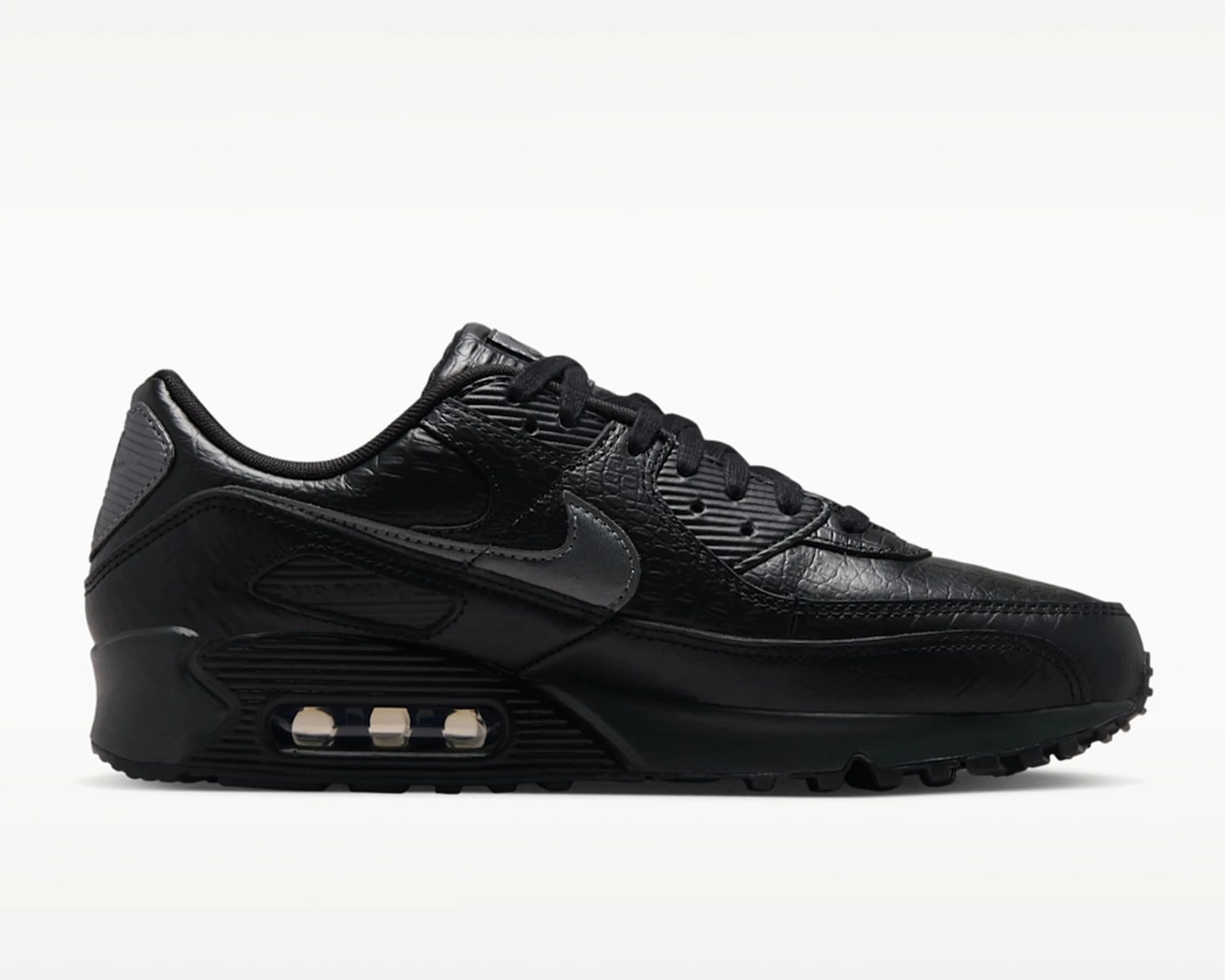 Black Nike Air Max sneaker with textured leather and visible air cushioning in the sole.