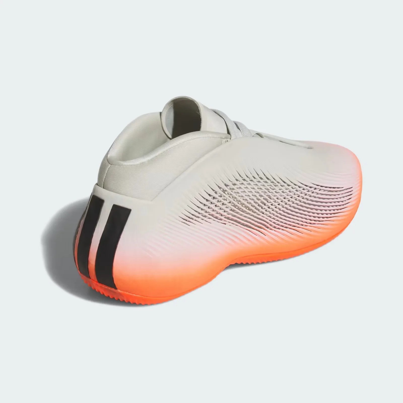 White athletic shoe with textured sides, black stripes on the heel, and an orange sole.