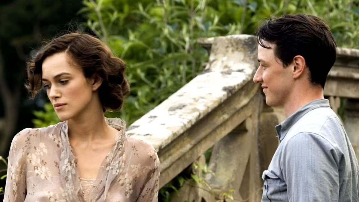 A man smiles at a woman turning away in