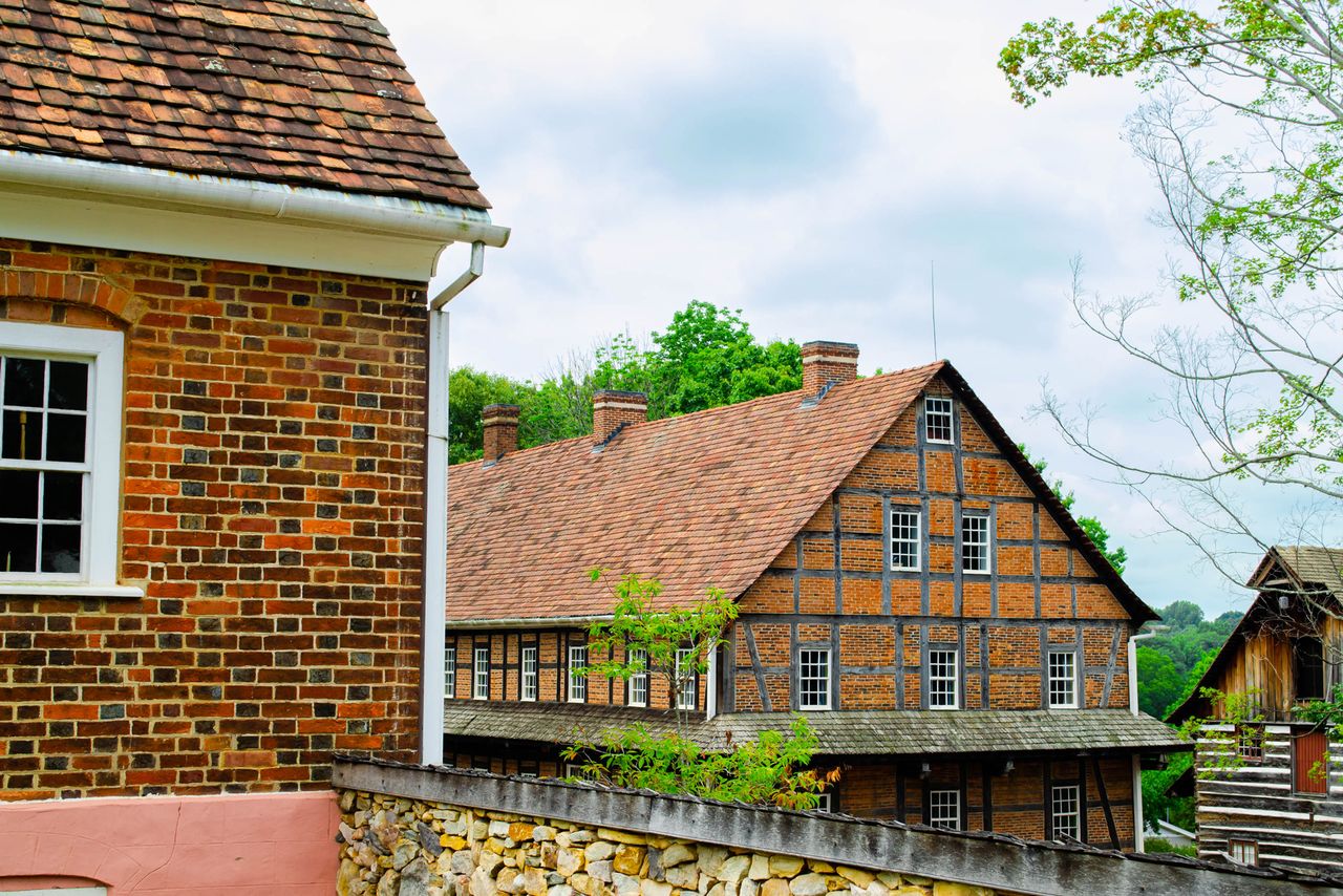 Historic brick and timber buildings part of a heritage site or village landscape