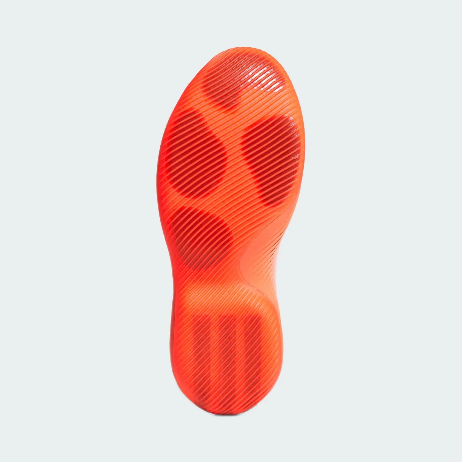 Bright orange shoe sole with textured diagonal lines and circular grip patterns.