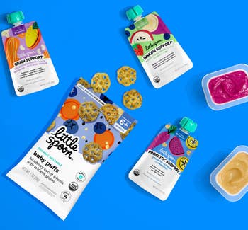 Baby snacks and purées from Little Spoon are arranged on a blue background, highlighting brain support, immune support, and probiotics