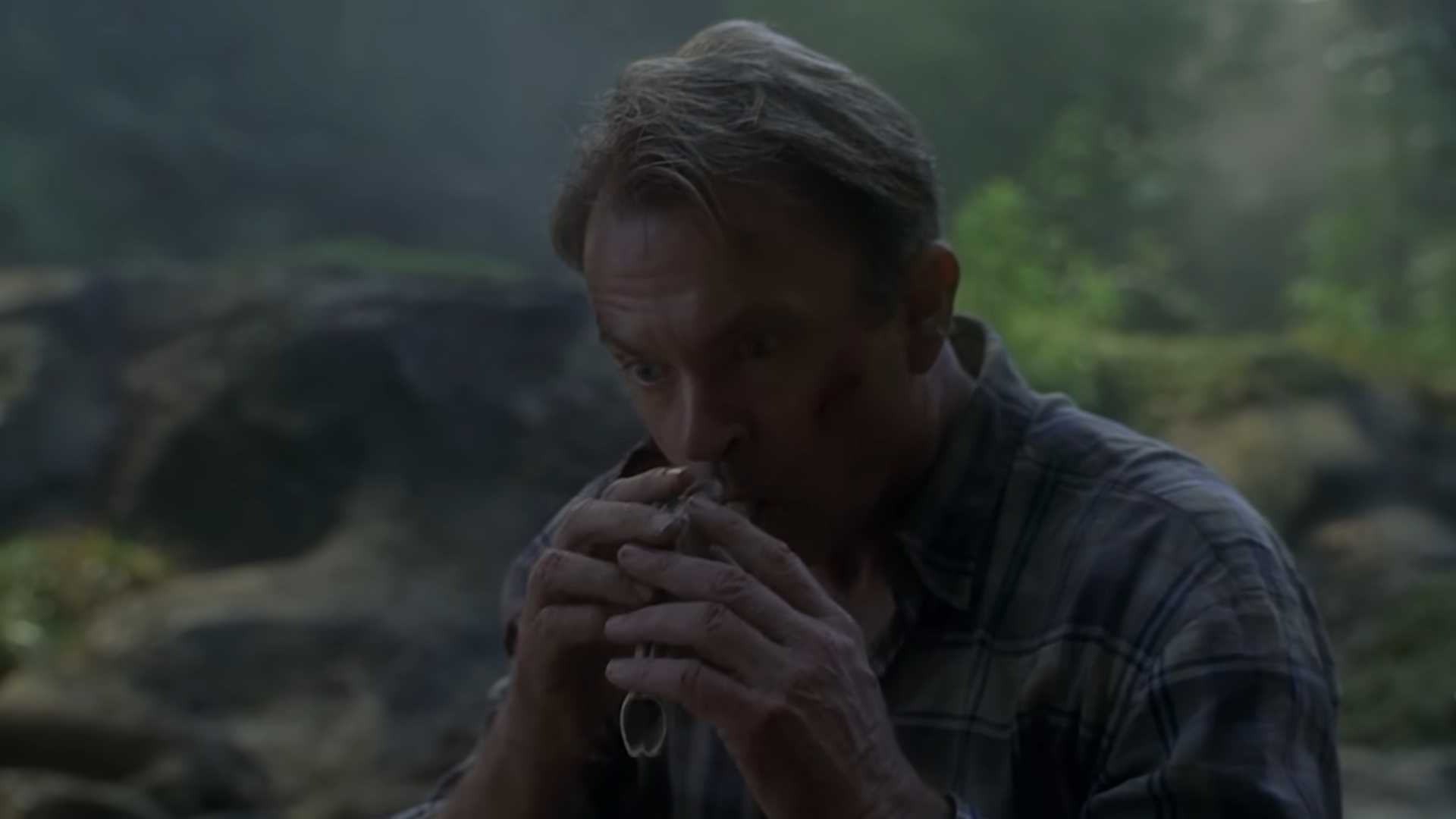Dr Grant (Sam Neill) blowing through a raptor resonating chamber in Jurassic Park III