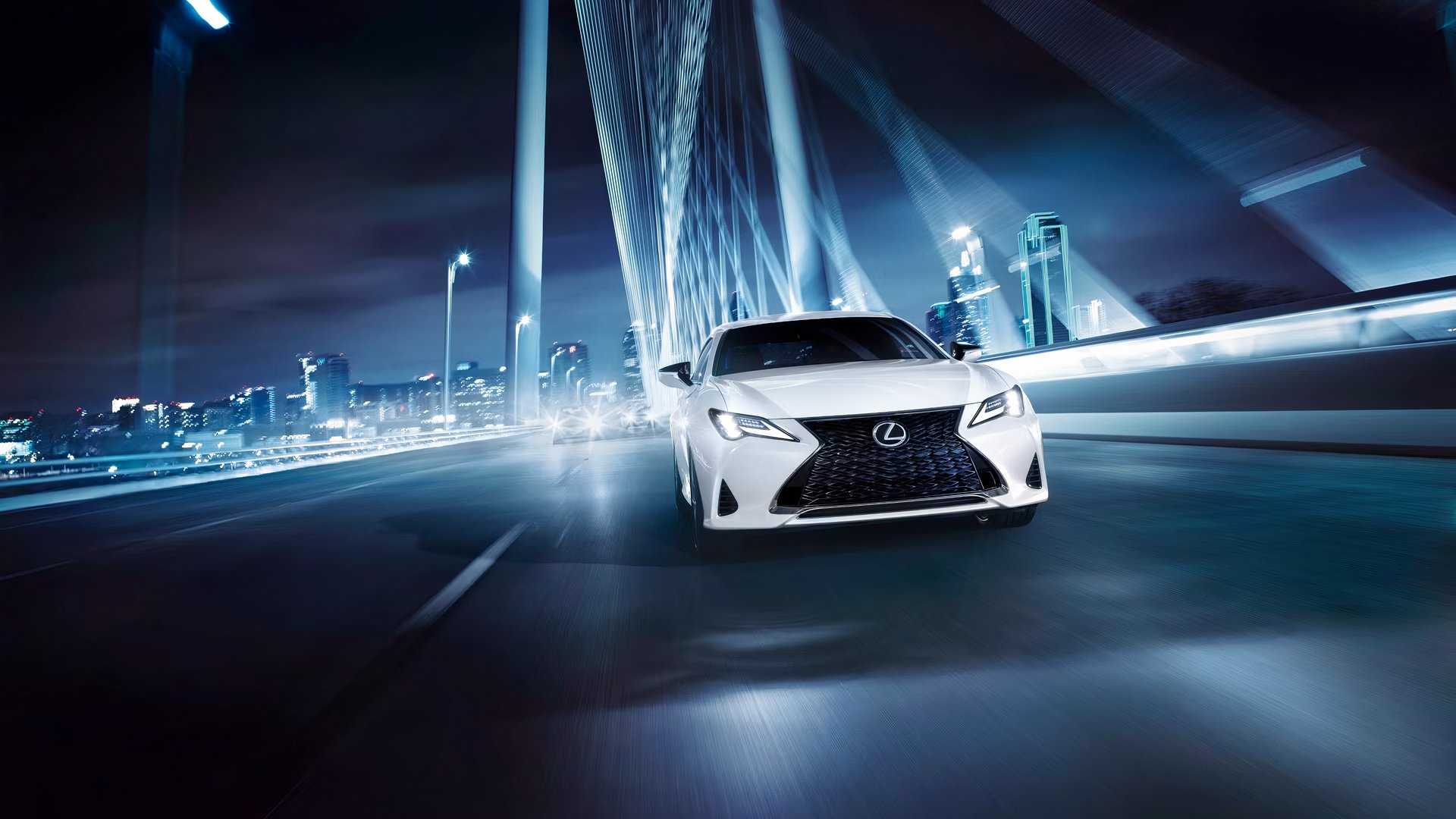 2025 Lexus RC front shot driving across a bridge at night
