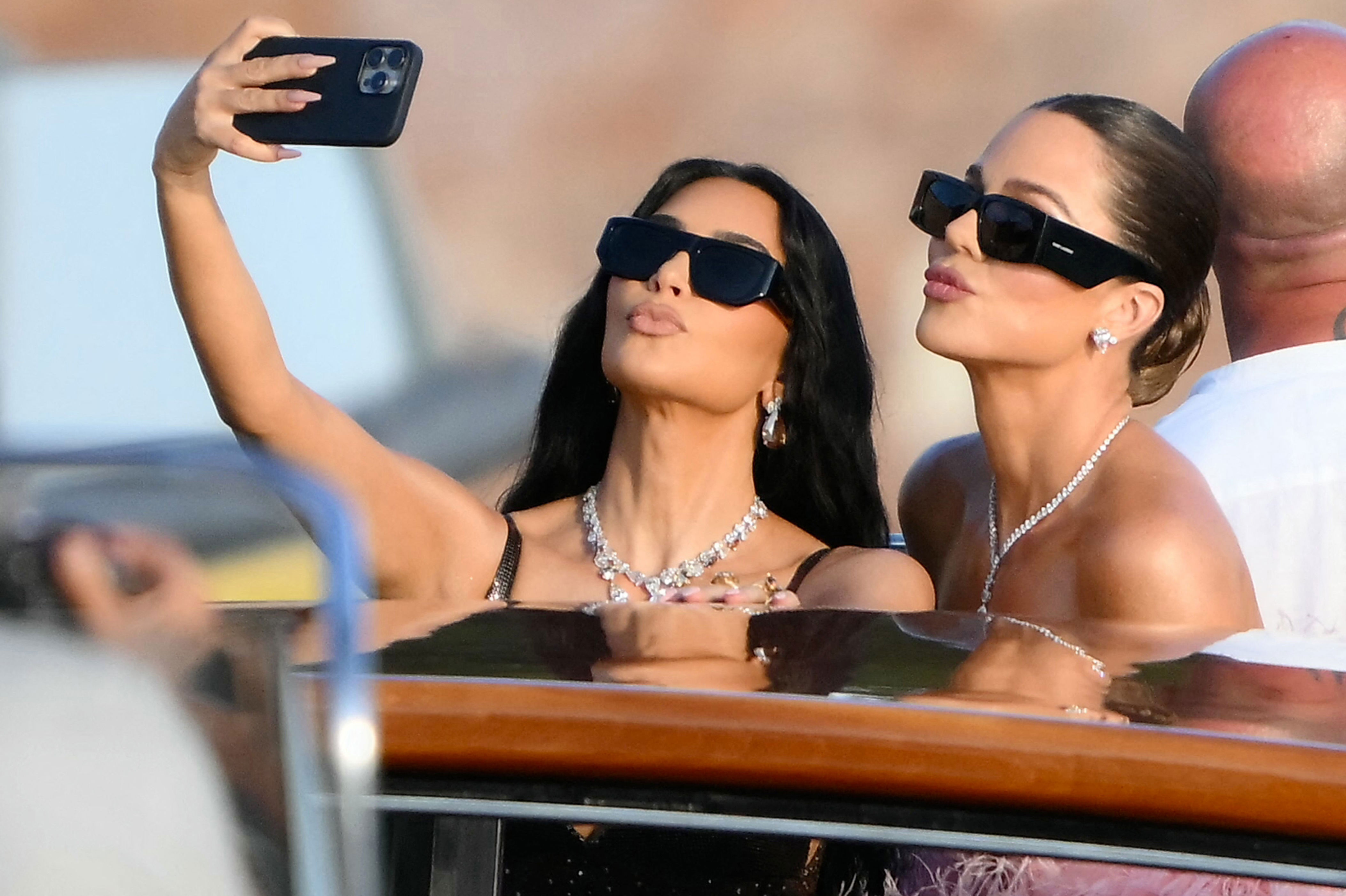 Kim Kardashian and Khloé Kardashian taking a selfie