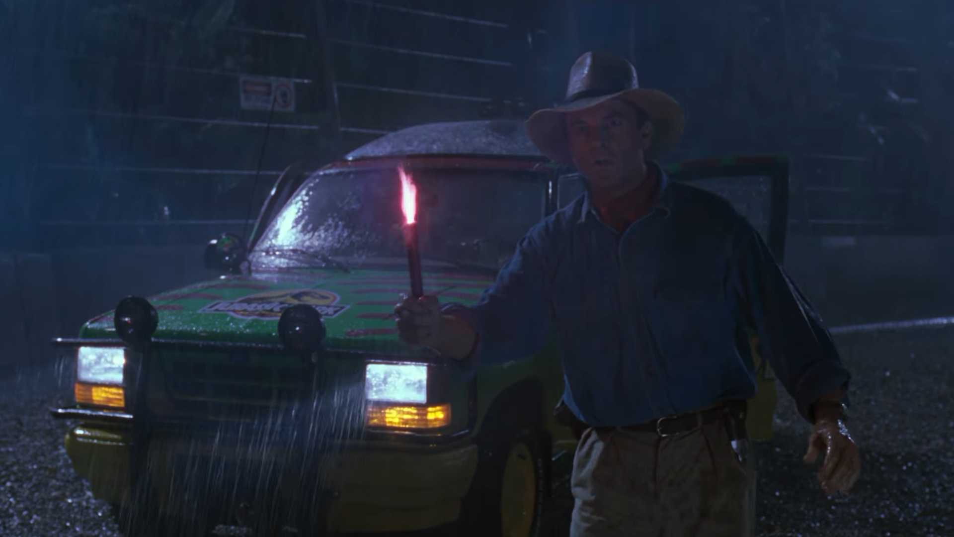 Dr Grant (Sam Neill) holding a flare as the t rex escapes in Jurassic Park