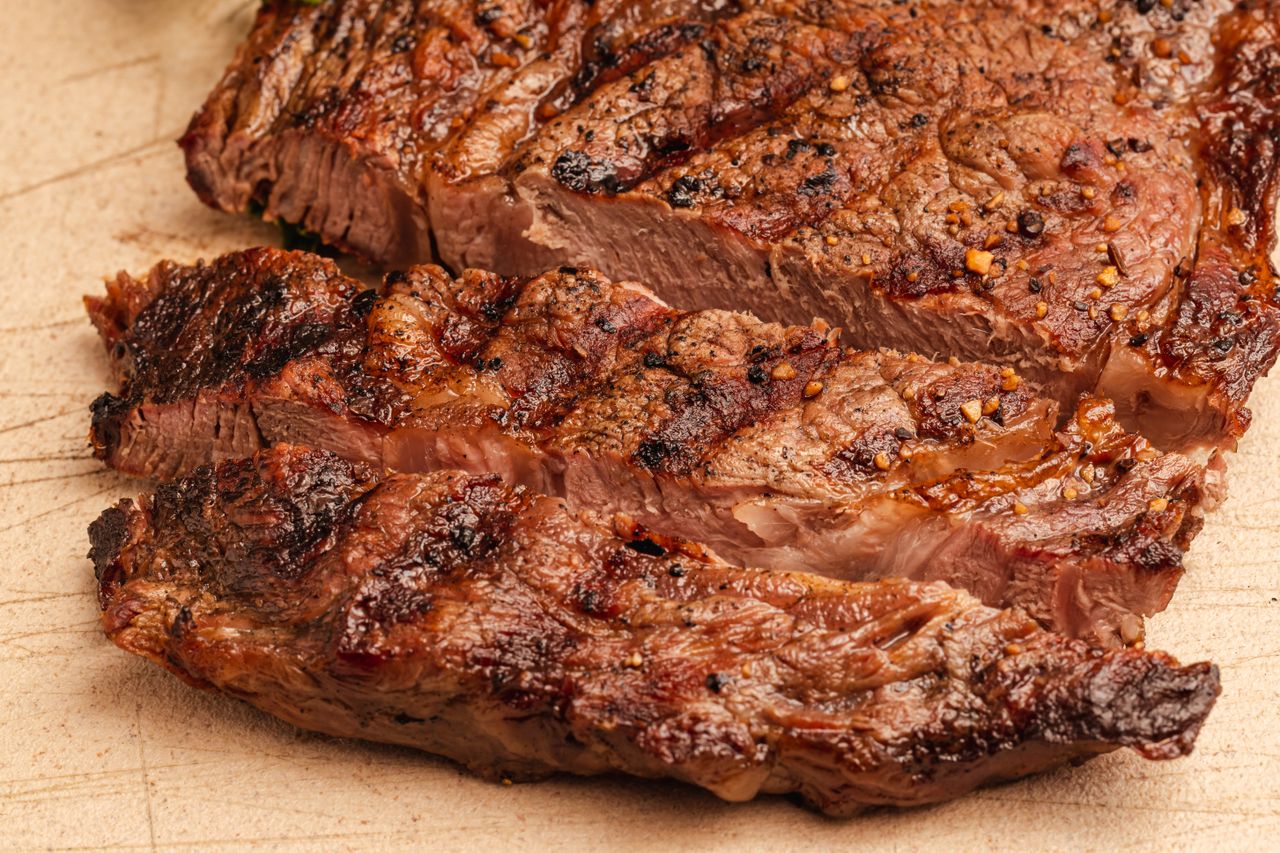 Cooked steak tips with charred exterior served on a cutting board