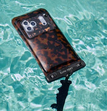 phone pouch with a tortoise shell design floating in the water
