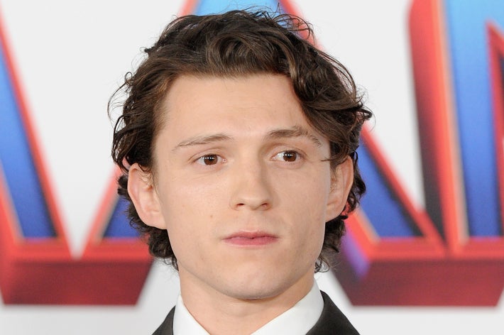 Tom Holland looks to his left at an event