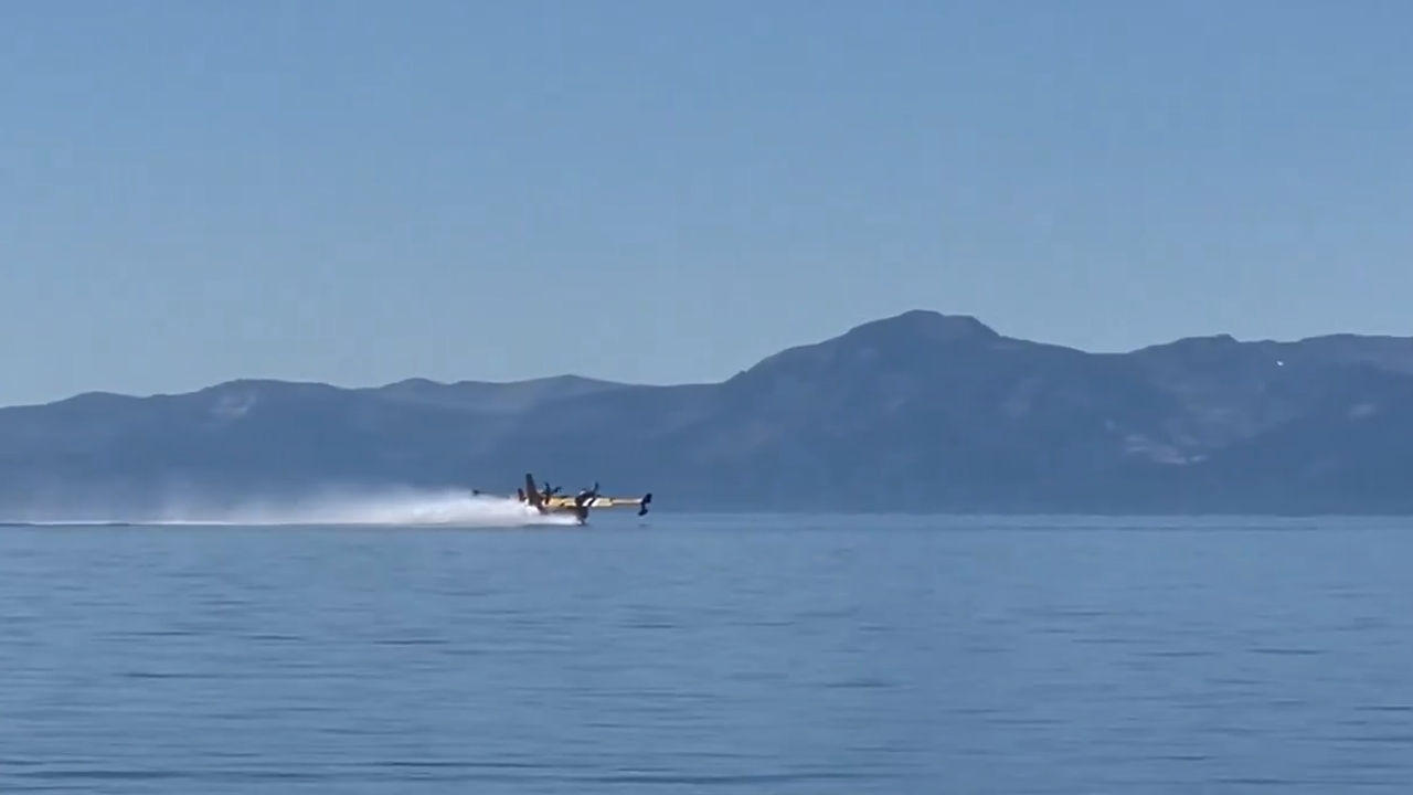 Plane scoops water from Cedar Beach to fight the Davis Fire in Nevada