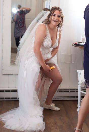 Reviewer in wedding dress applying Gold Bond Friction Defense to their inner thighs