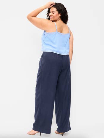 model wearing the pants in navy with a baby blue tank top
