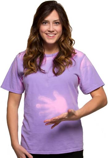 Smiling model in a heat-reactive T-shirt displaying a handprint change
