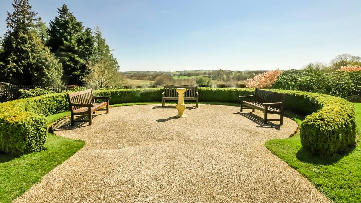 neat-gravel-path-with-benches-in-a-formal-garden