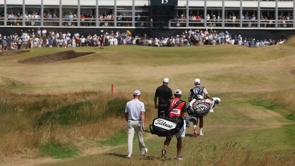 Golfers and their caddies walk up a grassy fairway toward a grandstand filled with spectators at the Open Championship, eager to catch Thursday highlights and relive any missed moments from the tournament.