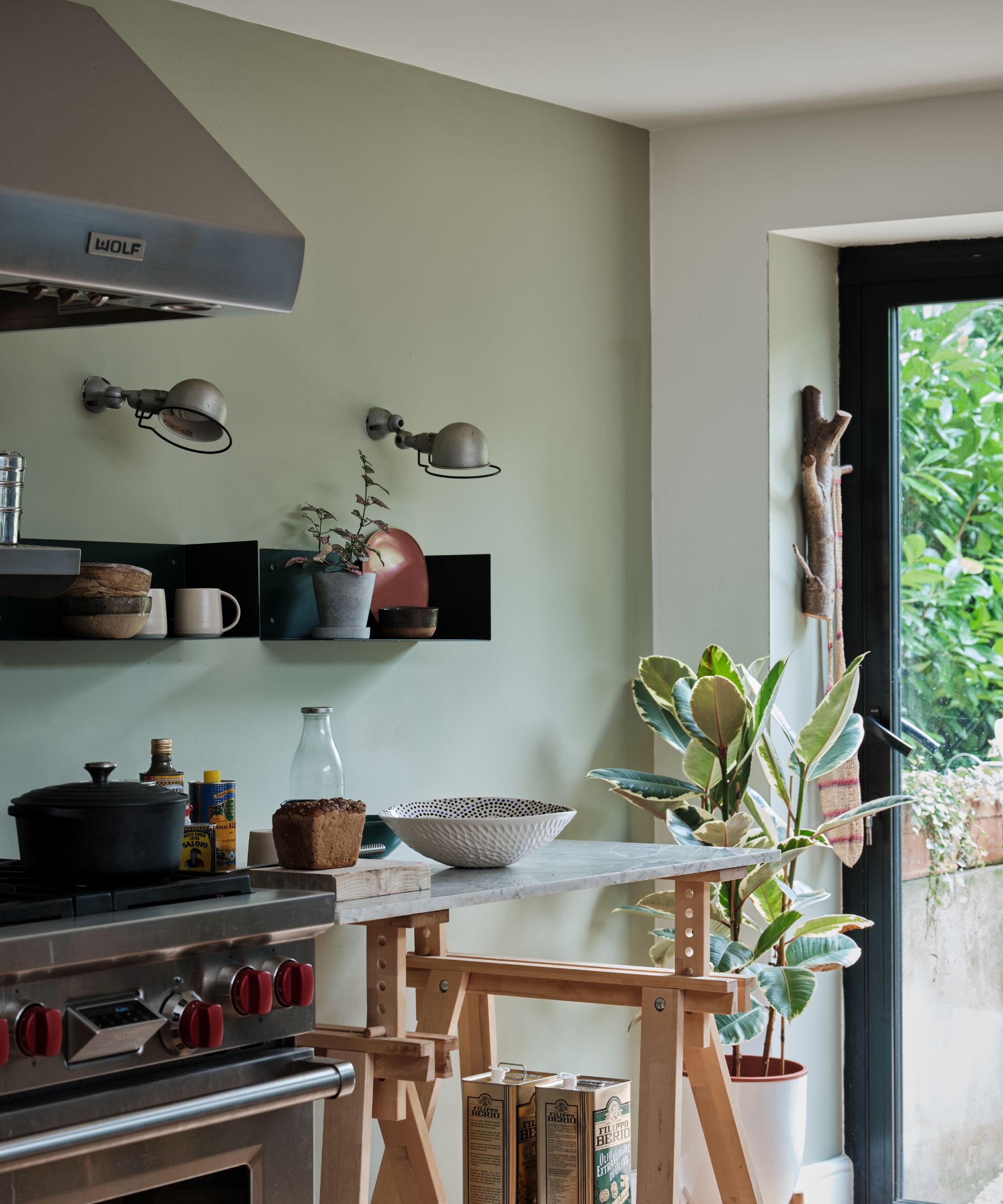 kitchen with gray-green wall, white wall and countertop with cookware