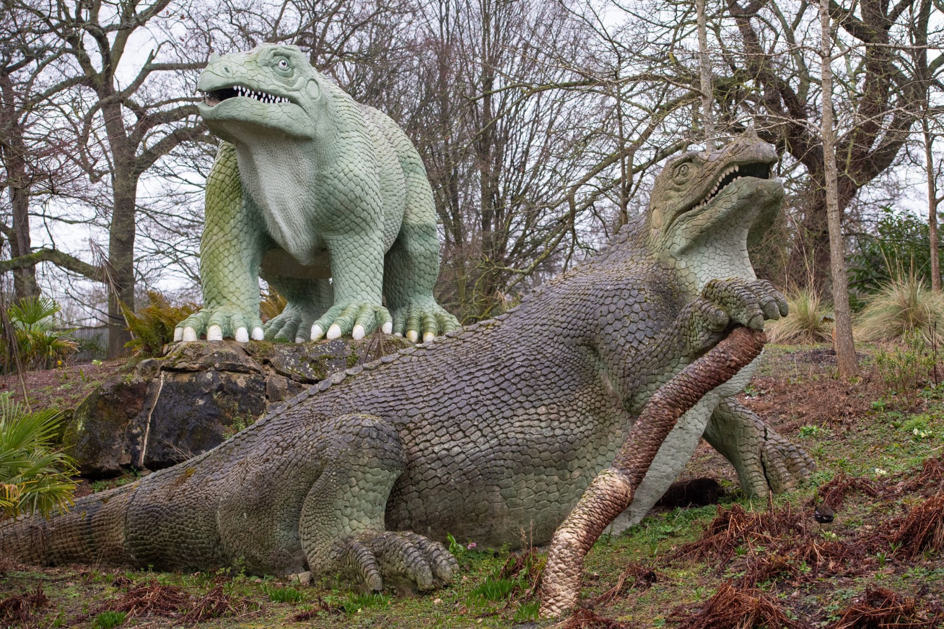 General view of two Iguanadon sculptures, part of the Crystal Palace Dinosuars, in Crystal Palace Park, London.