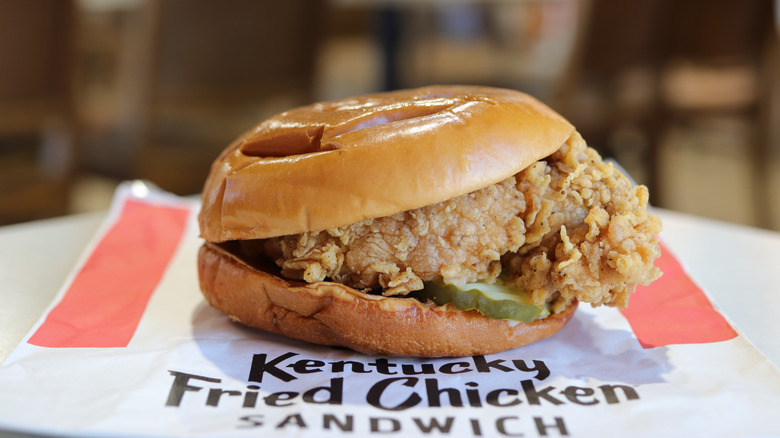 KFC chicken sandwich resting atop its branded wrapper