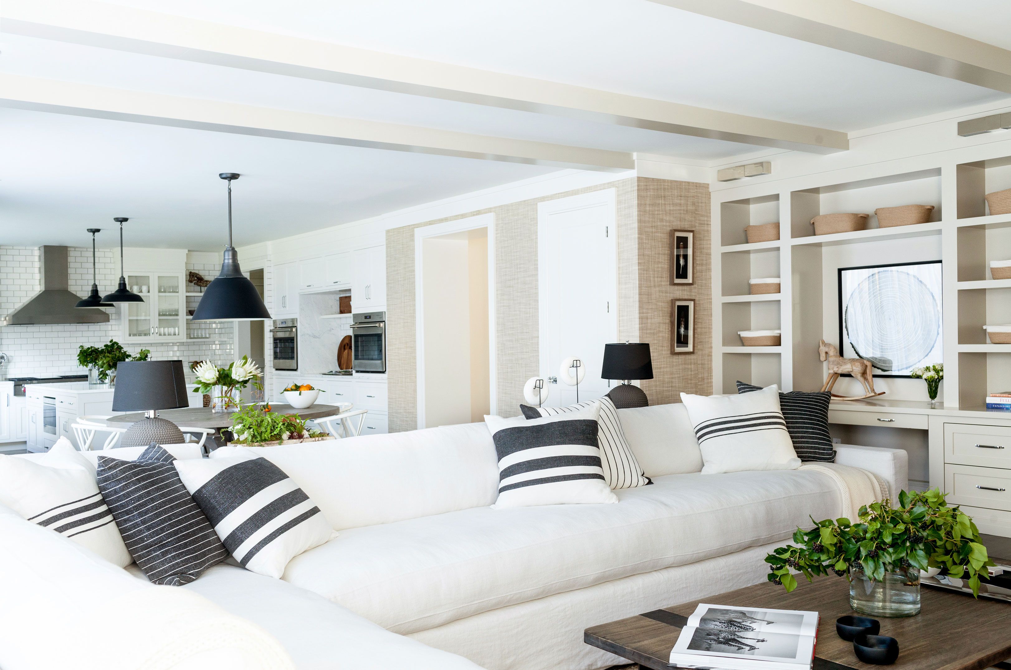 A large custom-made sectional with a white linen slipcover in a Connecticut living room by Chango & Co.