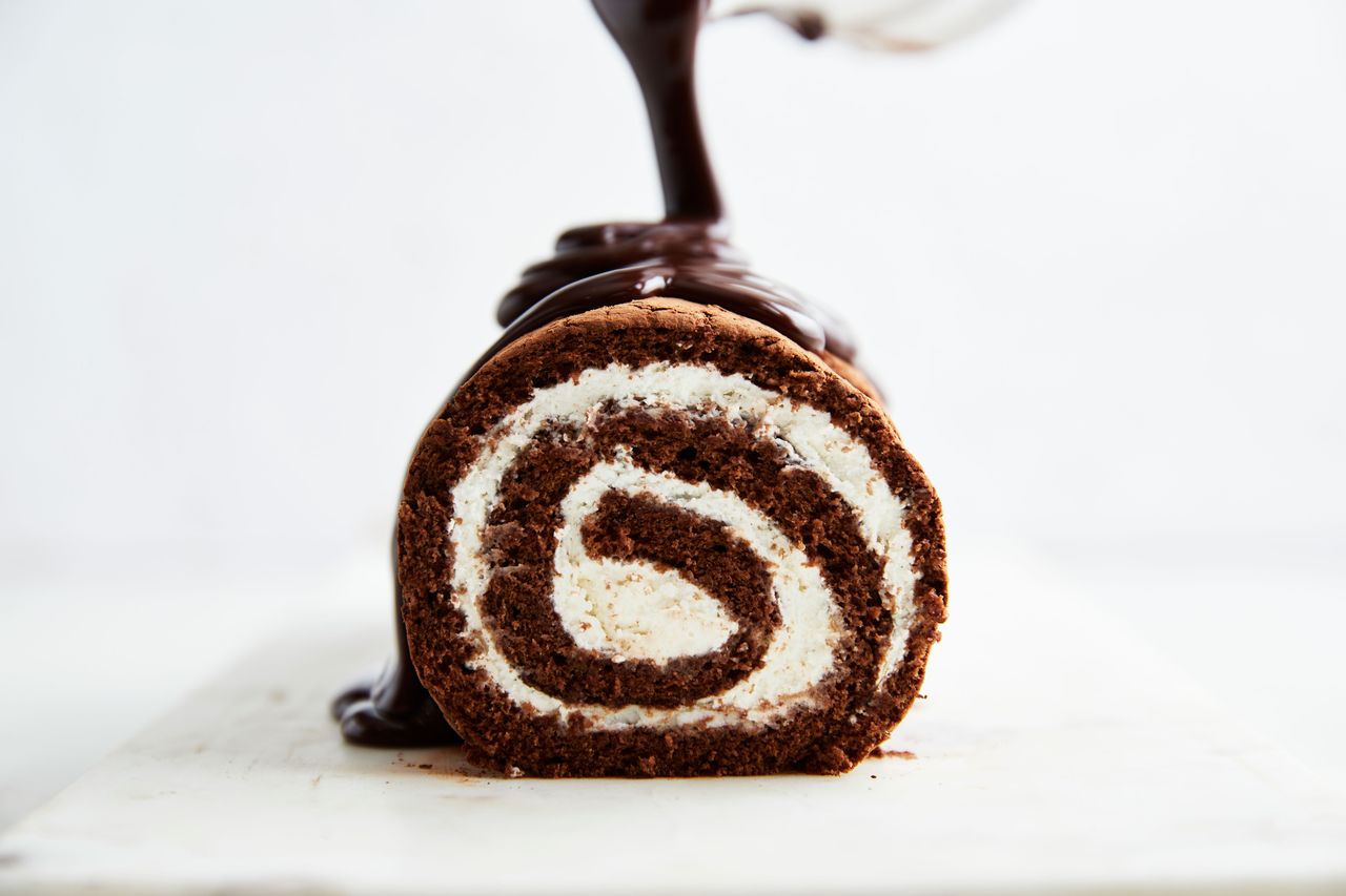 Southern Living Swiss Roll Cake pouring the ganache over the cake