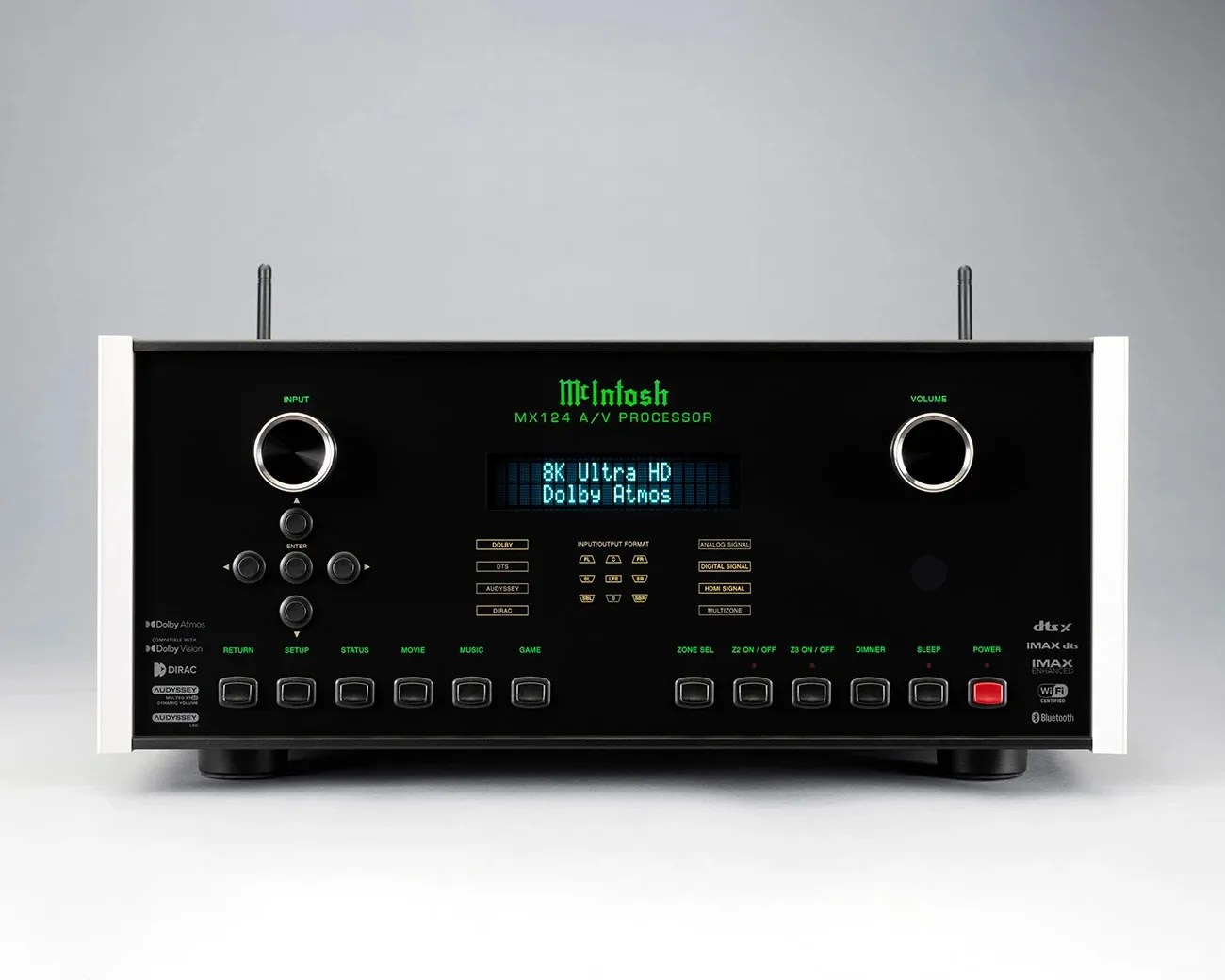 Black McIntosh MX124 A/V processor with green text display, silver knobs, and multiple buttons on a white surface.