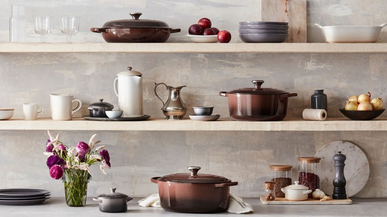 Two Le Creuset Dutch ovens and a braiser in Ganache, with other pieces in complementary whites and grays