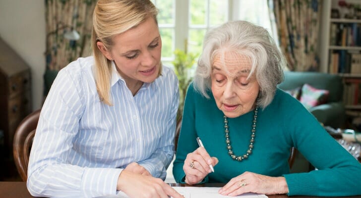 A mother and daughter review estate planning paperwork.