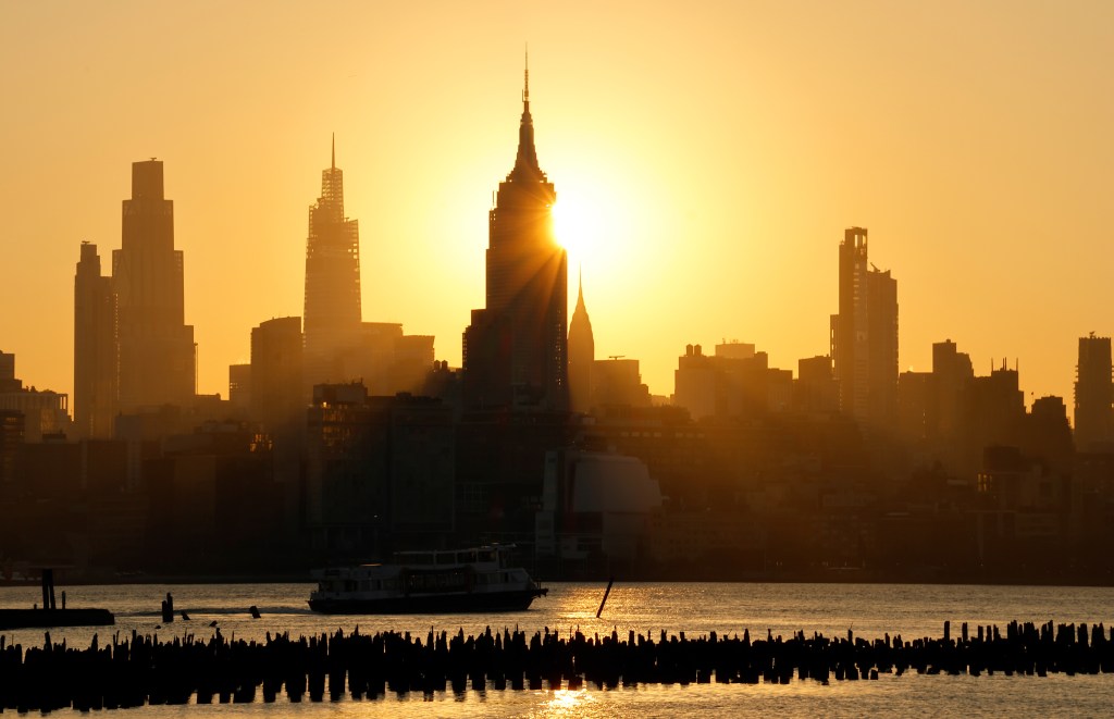 JERSEY CITY, NJ - JULY 15: The sun rises behind the skyline of midtown Manhattan and the Empire State Building in New York City as smoke from wildfires from Canada moves into the region on July 15, 2026, as seen from Jersey City, New Jersey. (Photo by Gary Hershorn/Getty Images)