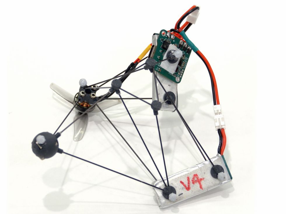A minimalist drone made of a few thin rods, wires and a miniature circuit board.