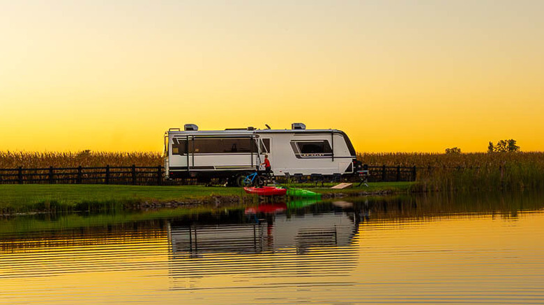 A Brinkley Model Z Air 310 RV at sunset along a waterway