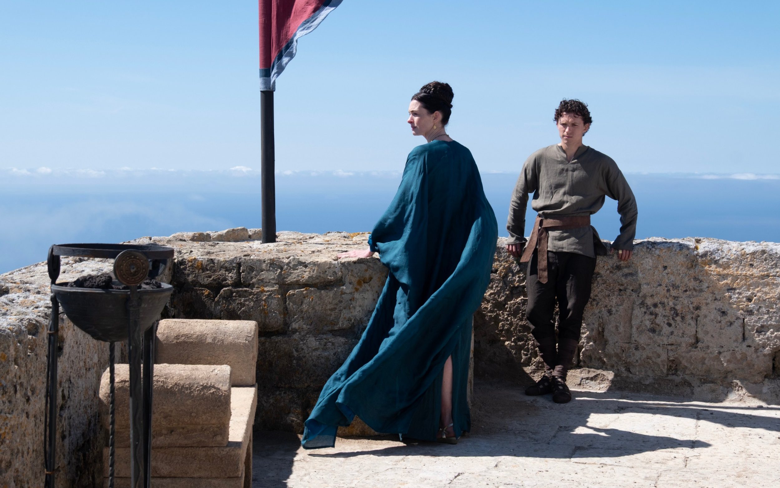 Anne Hathaway as Penelope, and Tom Holland as Telemachus, in a scene from