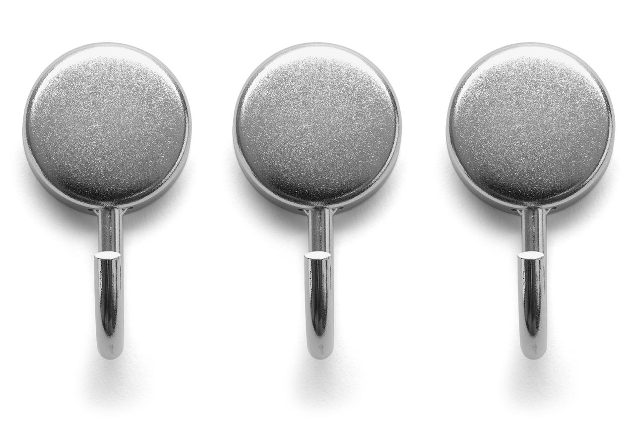 Three small round silver magnetic hooks in a row
