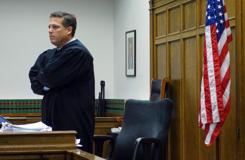 King County Superior Court Judge Roger Rogoff stands in court