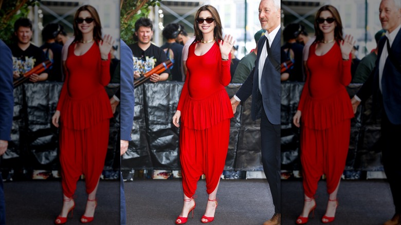 Anne Hathaway siled in a red outfit and heels