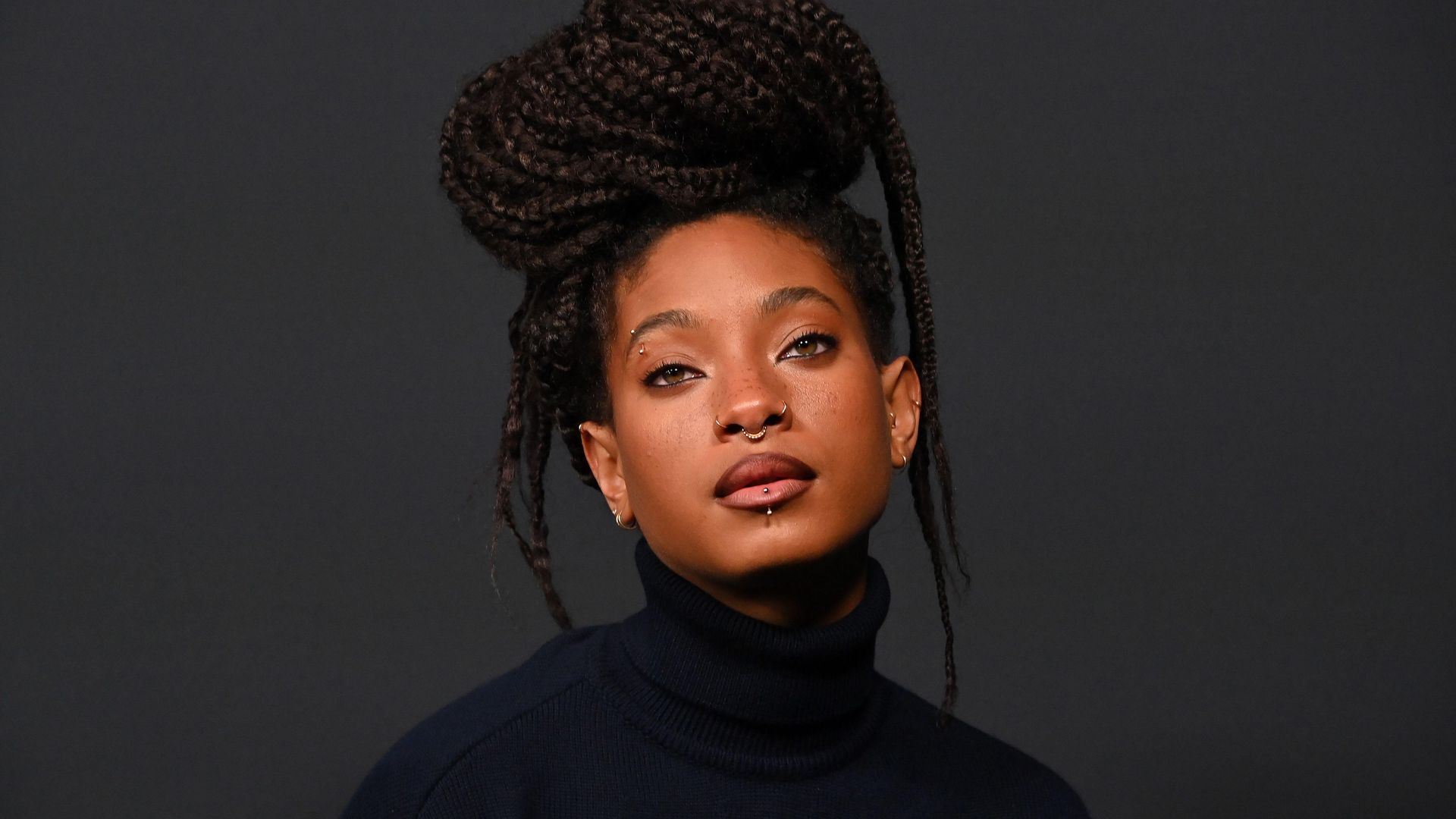 Willow Smith pairs electric blue eye makeup with emerald dress and pink tights for major announcement