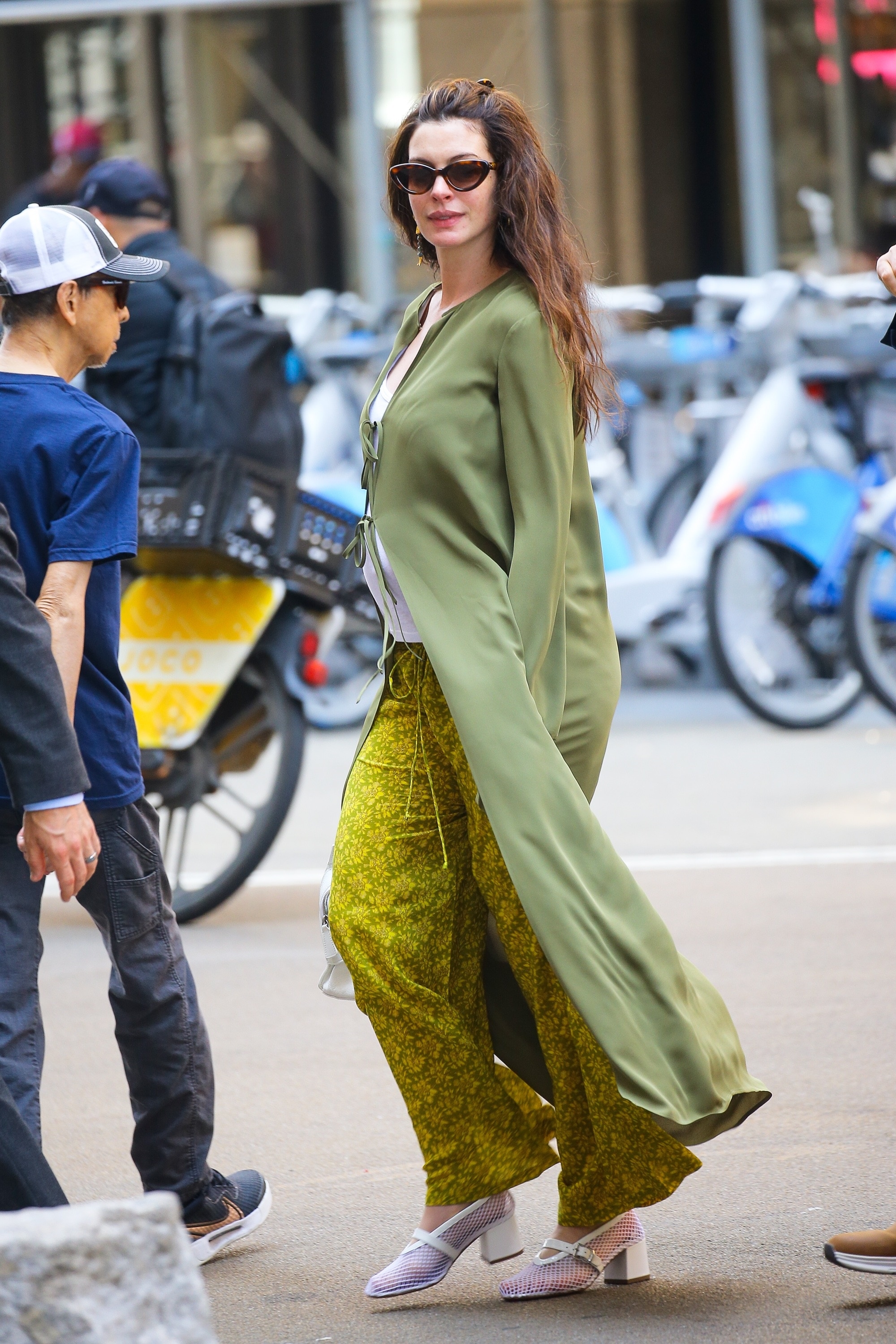 Anne Hathaway wore the hybrid mesh Mary Janes shoe trend with a green maternity outfit