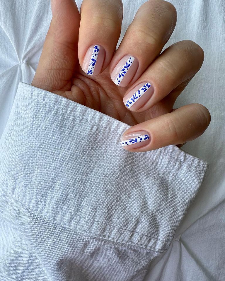 Nude nails with blue and white tile designs