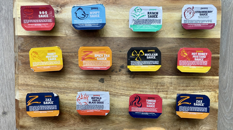 Assorted Zaxby Dipping sauces on a wooden cutting board